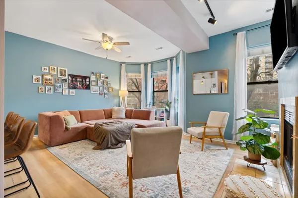 a living room with furniture a flat screen tv and a fireplace