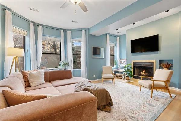 a living room with furniture a flat screen tv and a fireplace