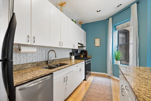a view of living room with kitchen island furniture and a flat screen tv
