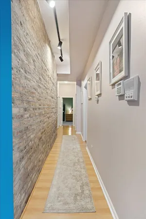 a bedroom with a bed and a flat tv screen on dresser