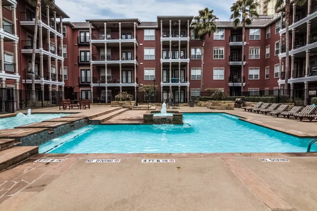 a front view of building with cars parked