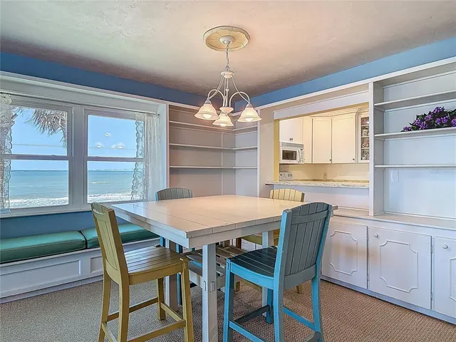 a view of a dining room with furniture window and outside view