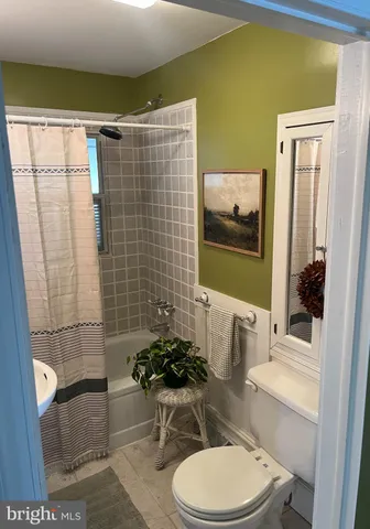 a bathroom with a toilet and shower