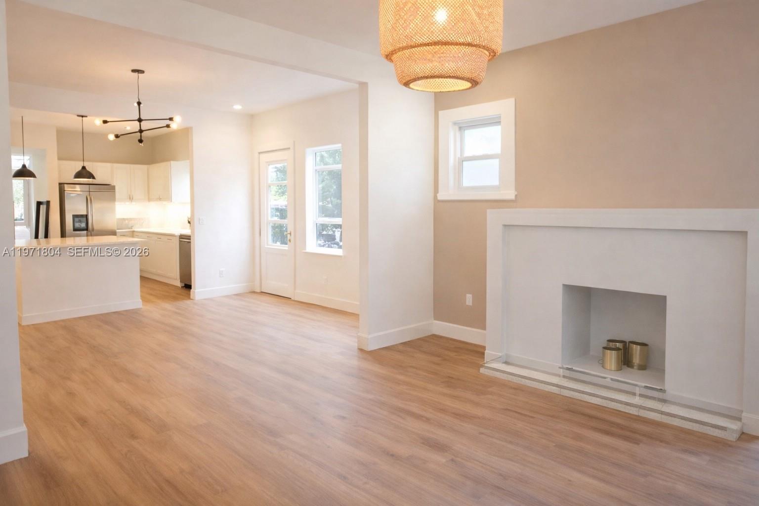 640 Northeast 71st Street Miami, FL 33138 - Photo 3 of 14 an empty room with windows and fireplace