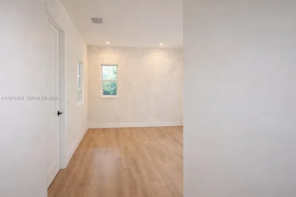 a view of an empty room and window