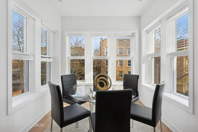 a view of a dining room with furniture and windows
