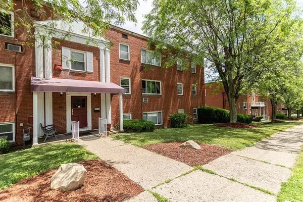 a front view of a building with a yard