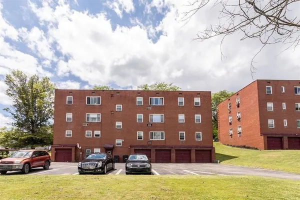 a front view of a building with garden