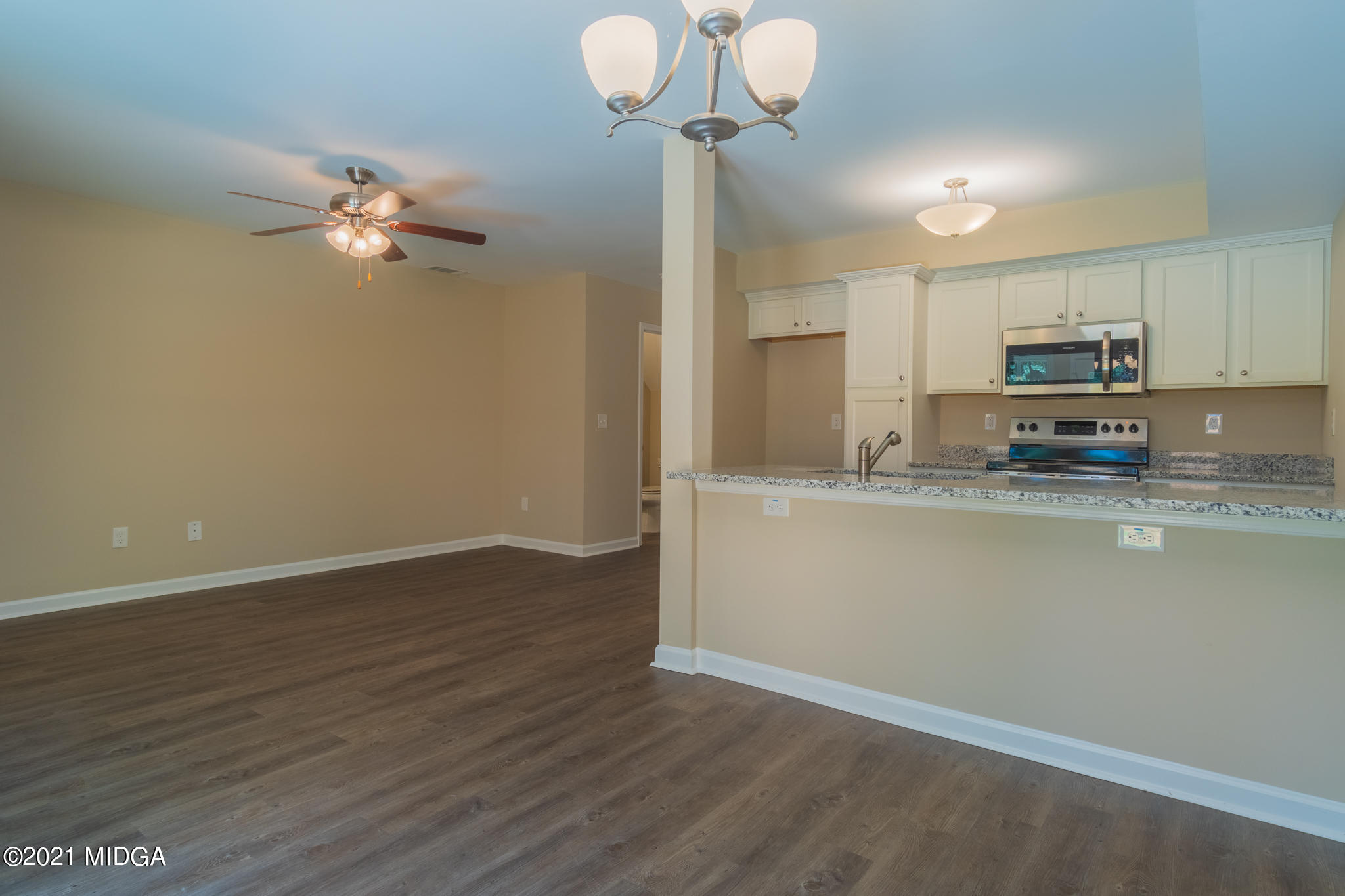 344 Pond View Road Macon, GA 31206 - Photo 5 of 22 a kitchen with kitchen island stainless steel appliances sink cabinets and wooden floor