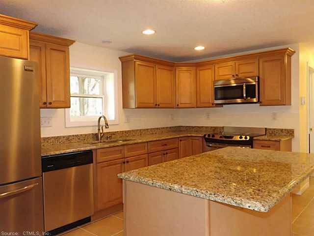 83 Robin Ridge Drive Madison, CT 06443 - Photo 1 of 1 a kitchen with stainless steel appliances granite countertop a sink stove and refrigerator