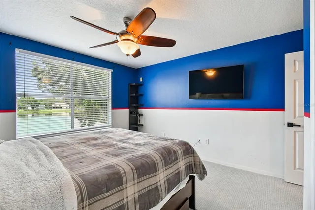 a view of a backyard with table and chairs under an umbrella