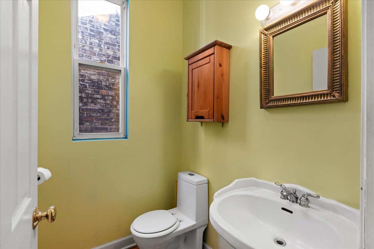 3145 West Augusta Boulevard, Unit 2 Chicago, IL 60622 - Photo 12 of 29 a bathroom with a toilet sink and mirror
