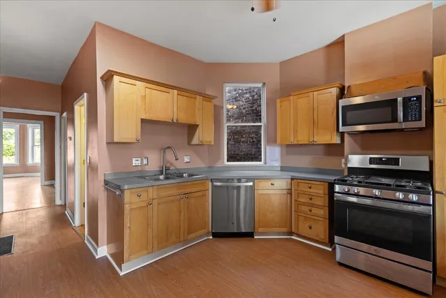 a kitchen with a sink appliances and furniture