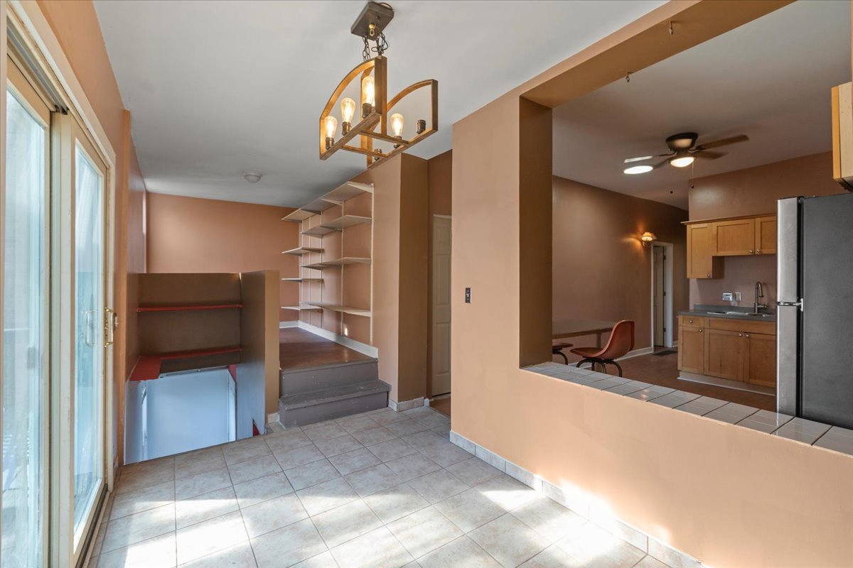 3145 West Augusta Boulevard, Unit 2 Chicago, IL 60622 - Photo 23 of 29 a view of a hallway with a living room and a chandelier