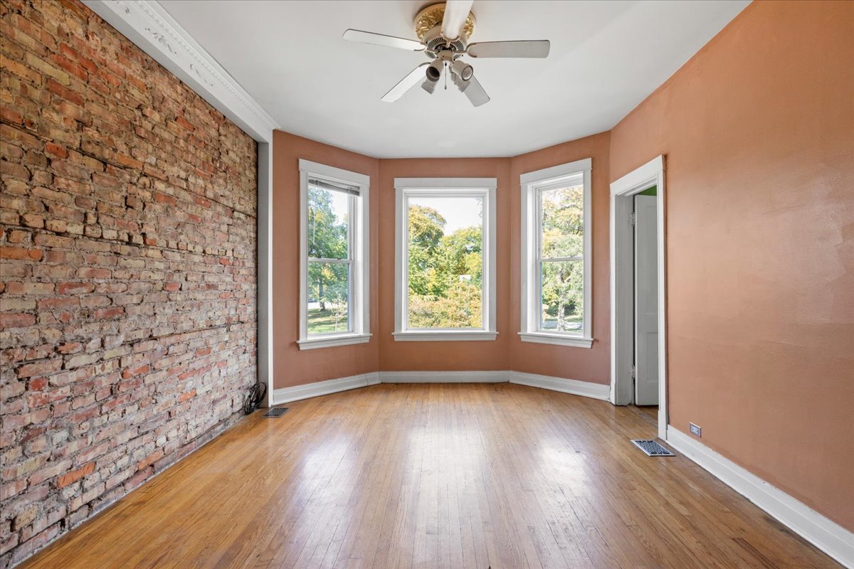 3145 West Augusta Boulevard, Unit 2 Chicago, IL 60622 - Photo 8 of 29 wooden floor in an empty room with a window