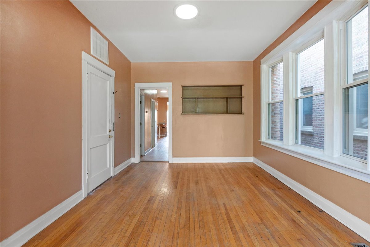 3145 West Augusta Boulevard, Unit 2 Chicago, IL 60622 - Photo 10 of 29 a view of a big room with wooden floor and windows