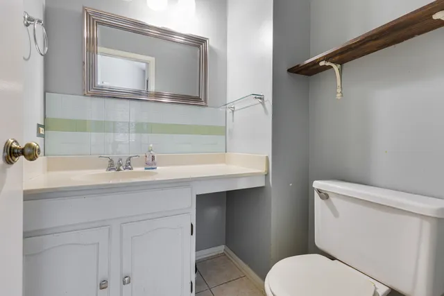 a bathroom with a sink toilet vanity and shower