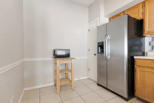 a kitchen with a refrigerator and microwave