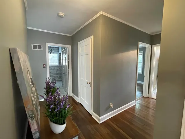 a view of a livingroom with wooden floor and a window