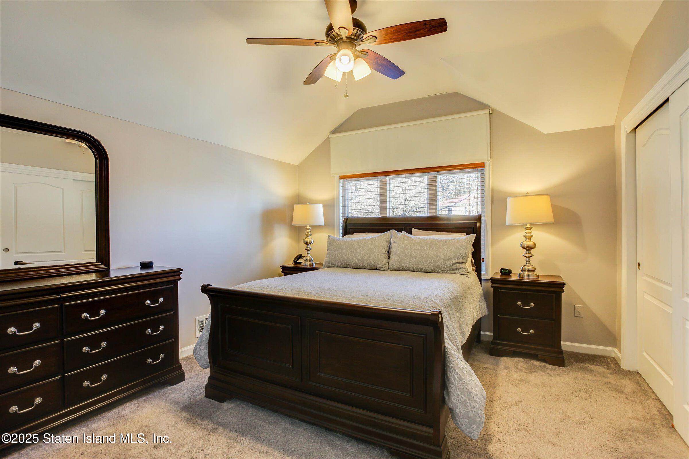 25 Gwenn Loop Staten Island, NY 10314 - Photo 13 of 32 a bedroom with a bed and a dresser