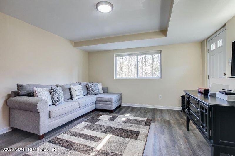 25 Gwenn Loop Staten Island, NY 10314 - Photo 20 of 32 a living room with furniture and a wooden floor