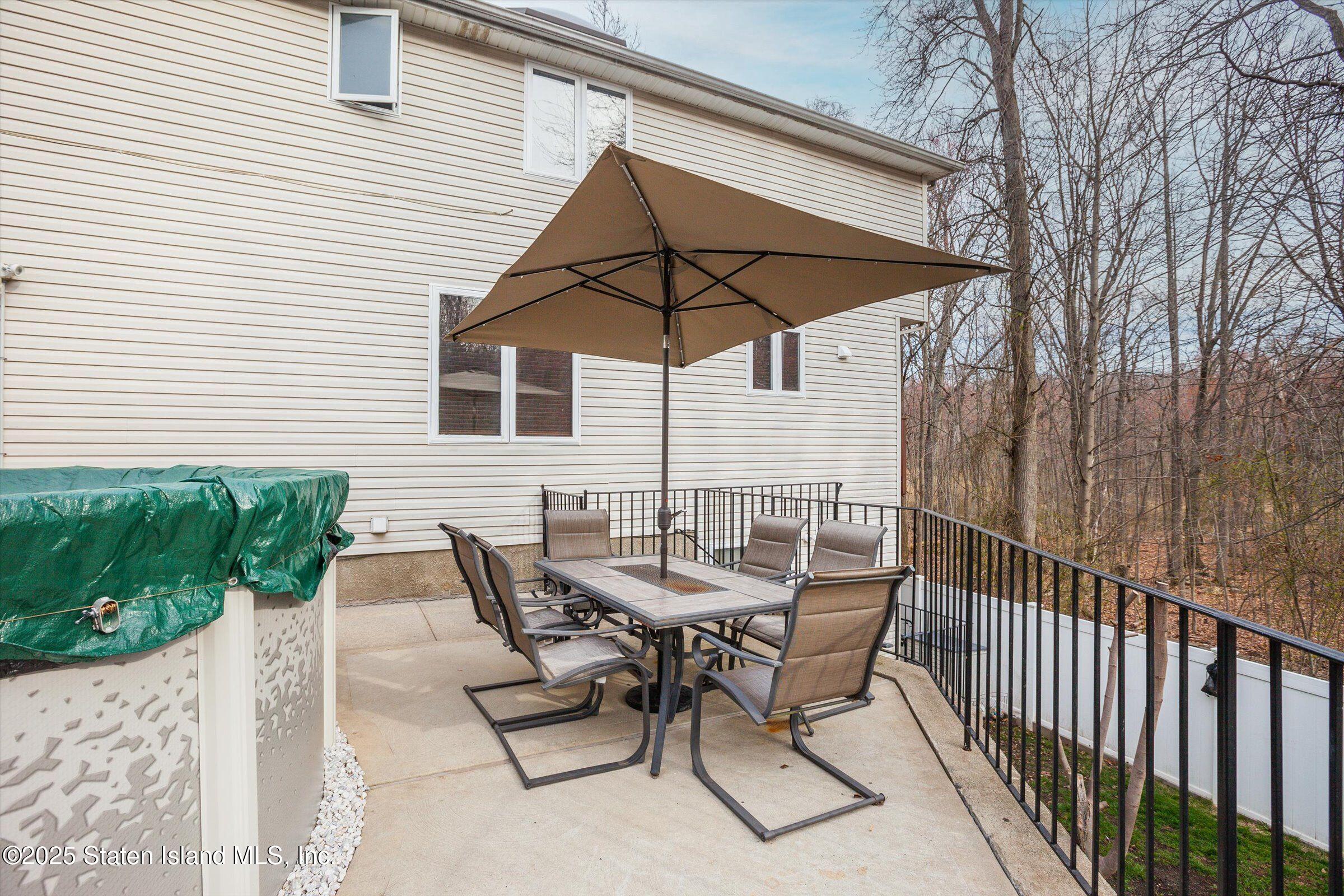 25 Gwenn Loop Staten Island, NY 10314 - Photo 22 of 32 a view of backyard with outdoor seating and wooden fence