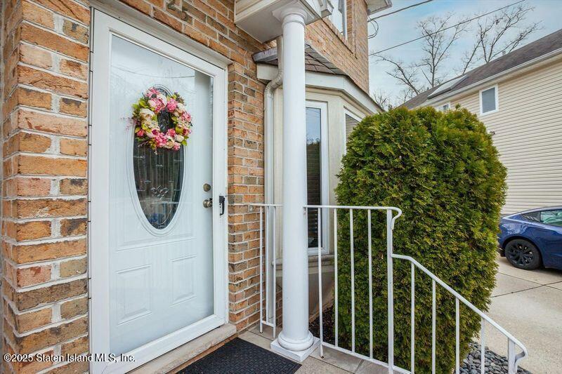 25 Gwenn Loop Staten Island, NY 10314 - Photo 3 of 32 a view of a door with a potted plant