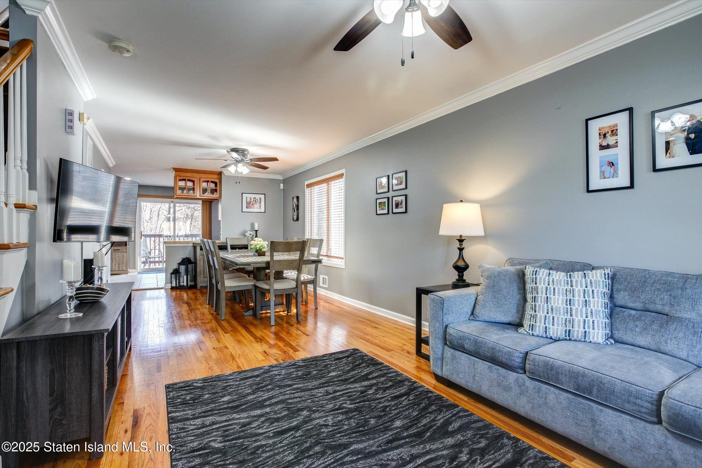 25 Gwenn Loop Staten Island, NY 10314 - Photo 4 of 32 a living room with furniture kitchen view and a chandelier