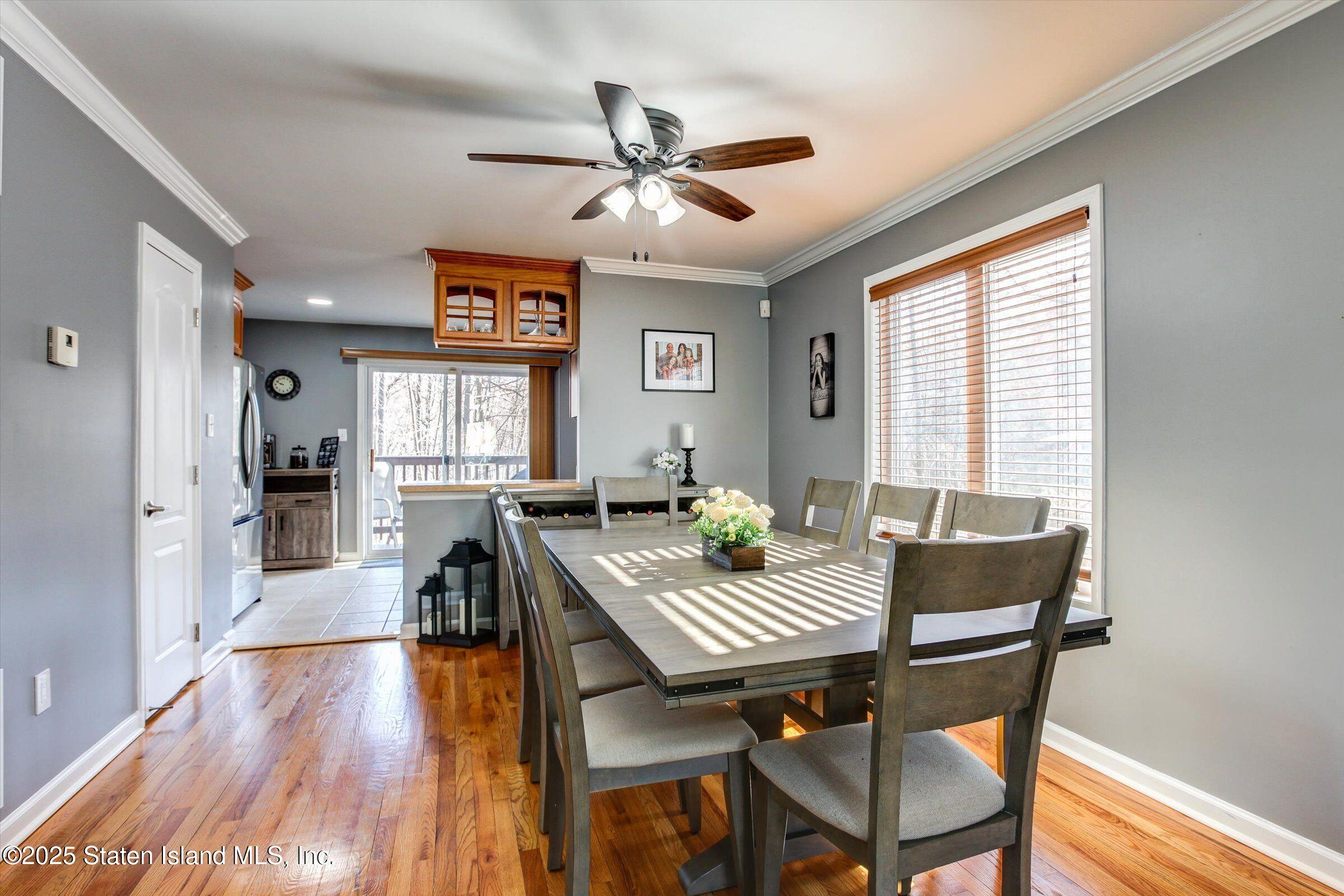 25 Gwenn Loop Staten Island, NY 10314 - Photo 6 of 32 a view of a dining room with furniture window and wooden floor