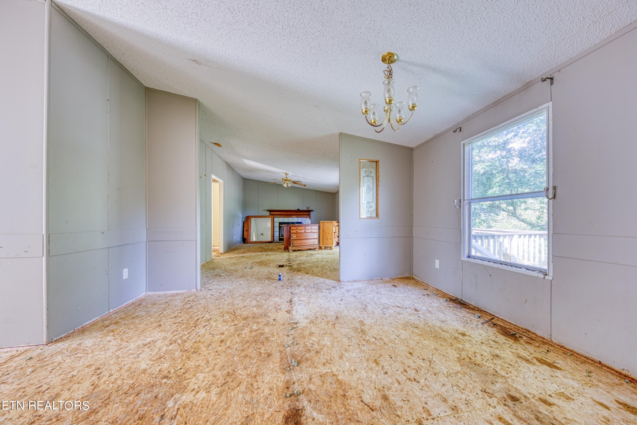 8504 Childress Road Powell, TN 37849 - Photo 11 of 15 a view of an empty room with window and a kitchen