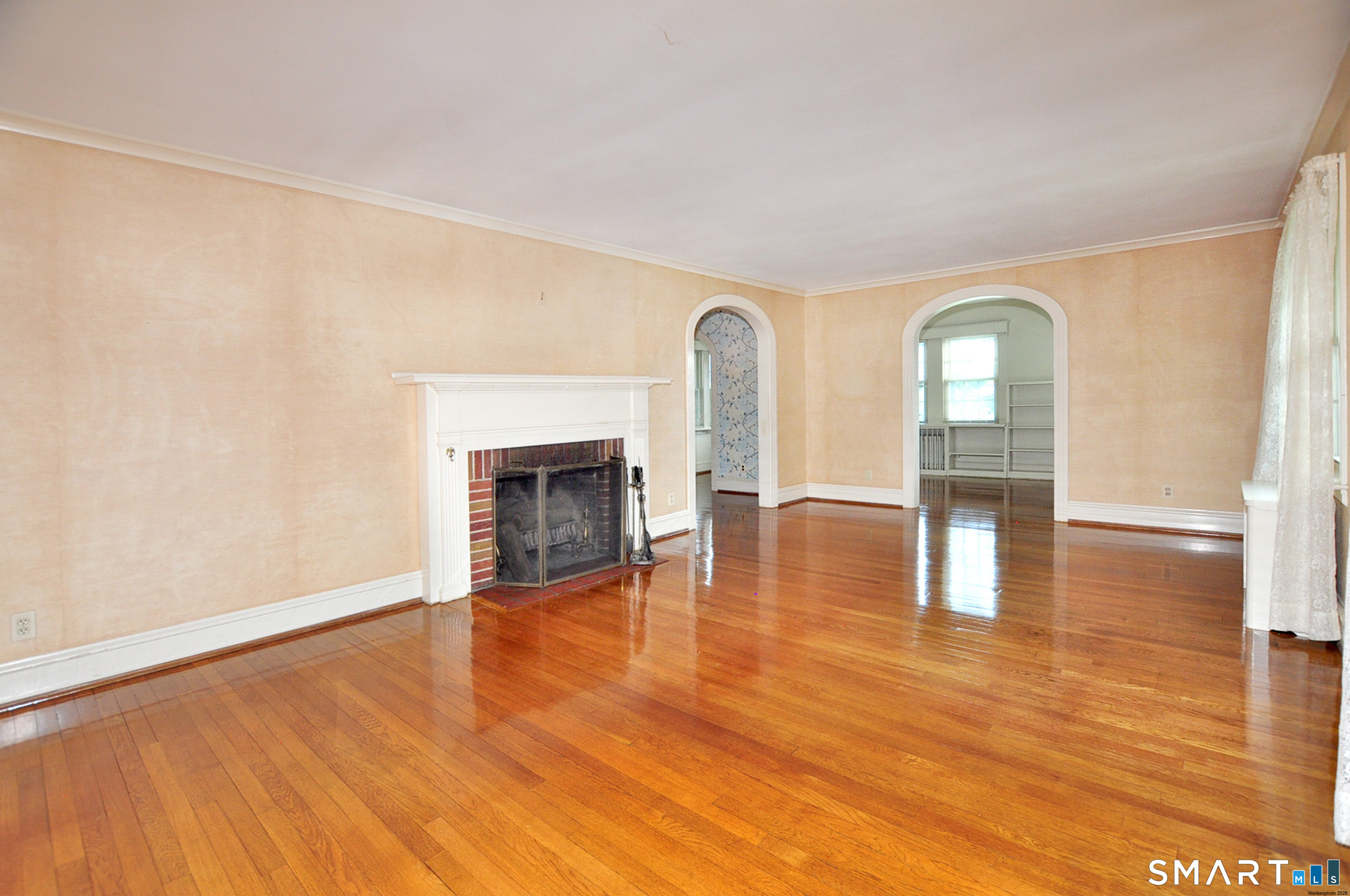 10 Harvey Road Windsor, CT 06095 - Photo 4 of 36 a view of empty room with wooden floor and fireplace