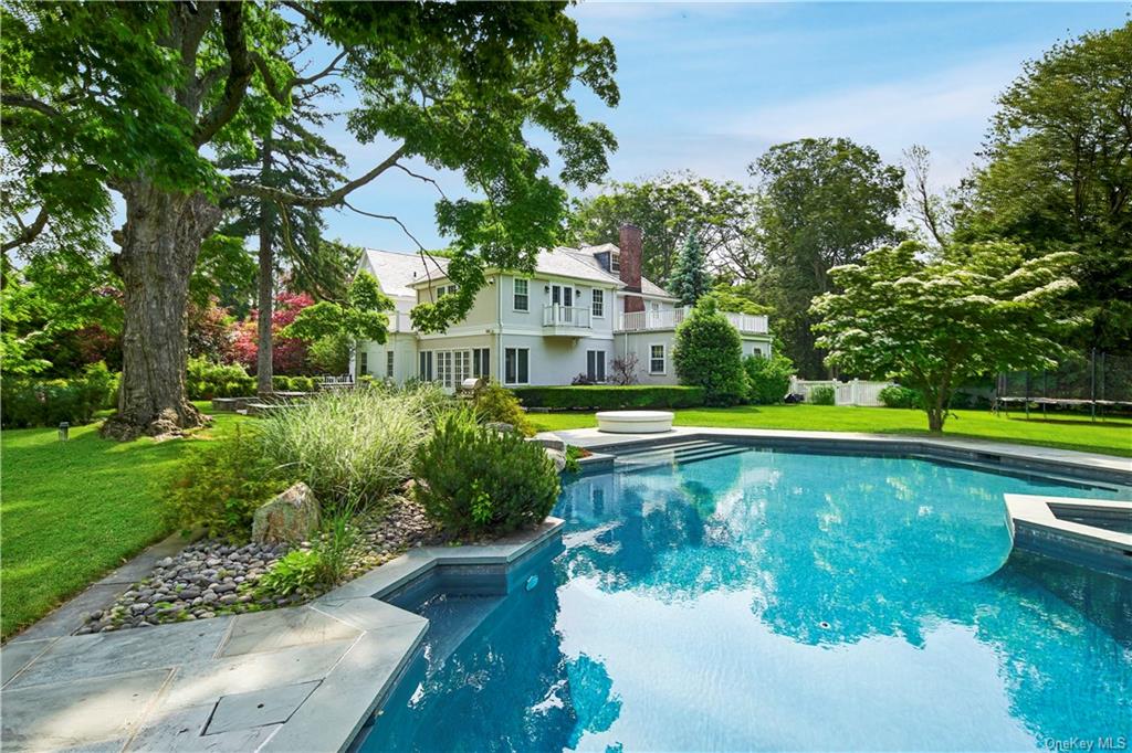 83 Garden Road Scarsdale, NY 10583 - Photo 1 of 1 a view of a house with a yard and swimming pool