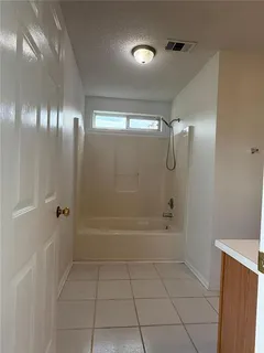 a bathroom with a bathtub and shower