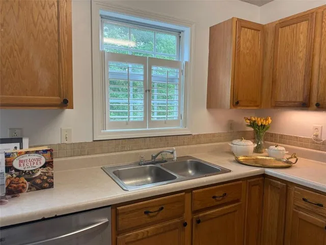 a kitchen with a sink cabinets and window