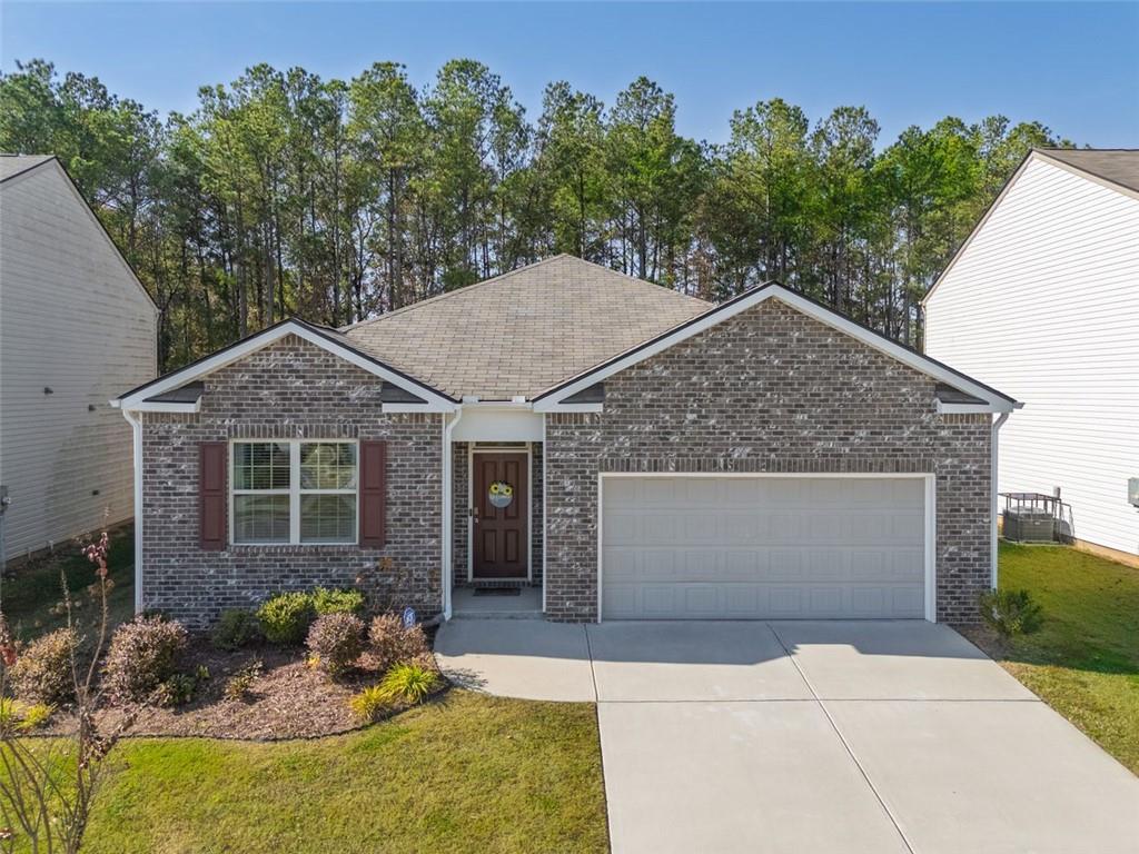 3841 Makeover Court Atlanta, GA 30349 - Photo 1 of 44 a front view of a house with garden