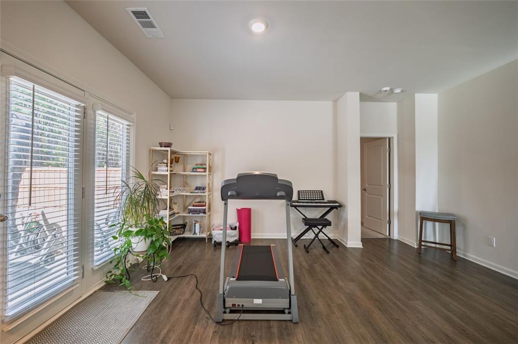 3841 Makeover Court Atlanta, GA 30349 - Photo 15 of 44 a room with furniture and a wooden floor
