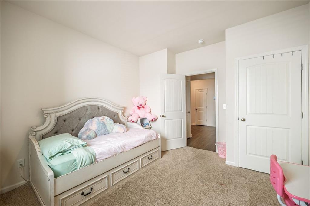 3841 Makeover Court Atlanta, GA 30349 - Photo 26 of 44 a bedroom with a bed and closet