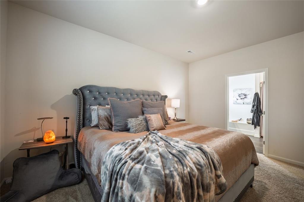 3841 Makeover Court Atlanta, GA 30349 - Photo 28 of 44 a bedroom with a bed and a lamp