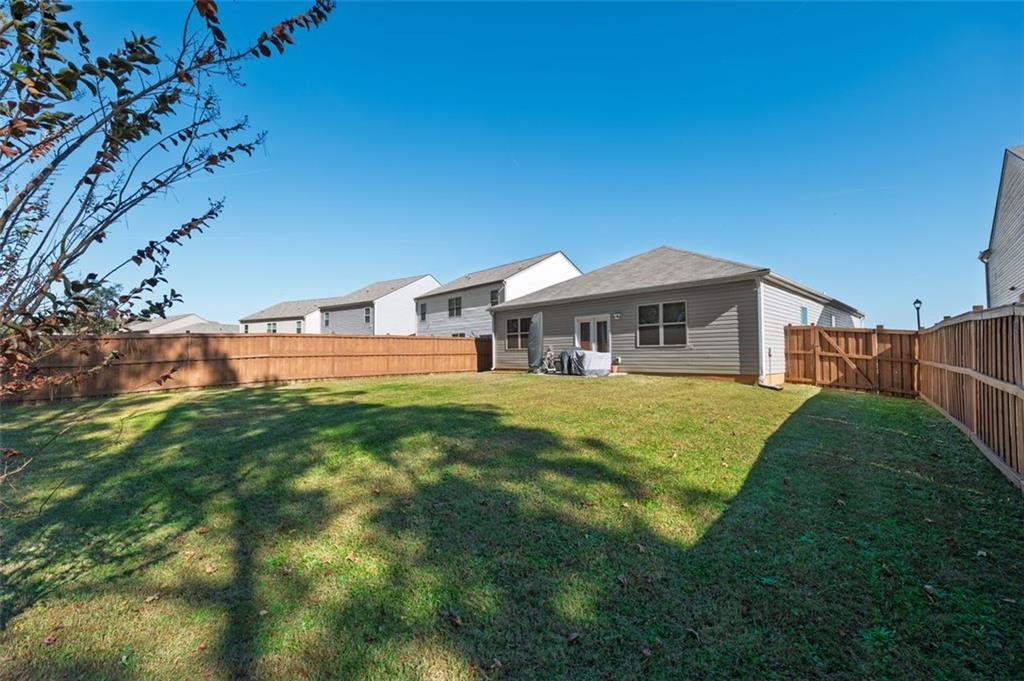 3841 Makeover Court Atlanta, GA 30349 - Photo 34 of 44 a front view of a house with a yard