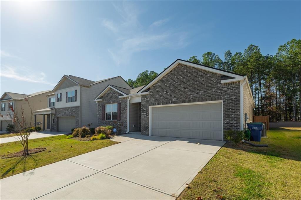 3841 Makeover Court Atlanta, GA 30349 - Photo 4 of 44 a front view of a house with a yard