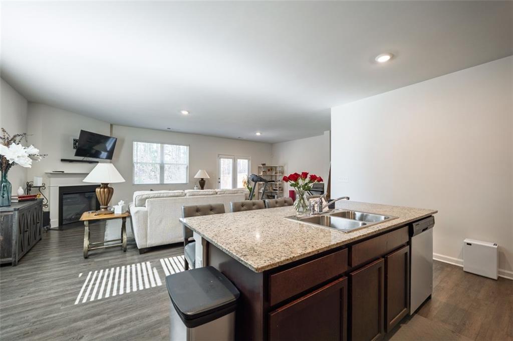 3841 Makeover Court Atlanta, GA 30349 - Photo 7 of 44 a kitchen with a table chairs and wooden floor