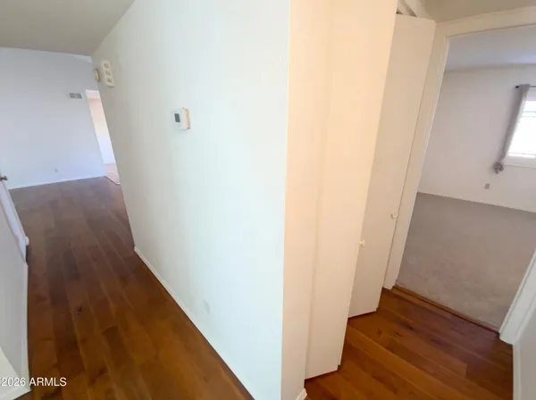 a view of a hallway with wooden floor