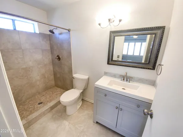 a bathroom with a toilet sink and shower