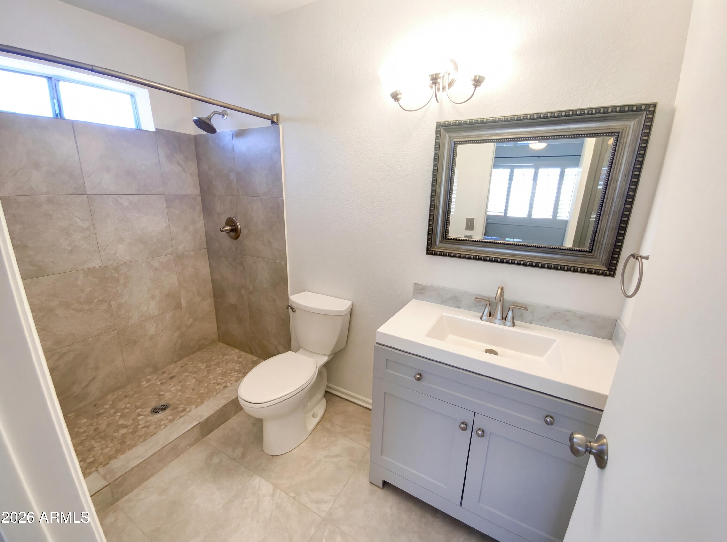 8508 West Ruth Avenue Peoria, AZ 85345 - Photo 15 of 17 a bathroom with a toilet sink and shower