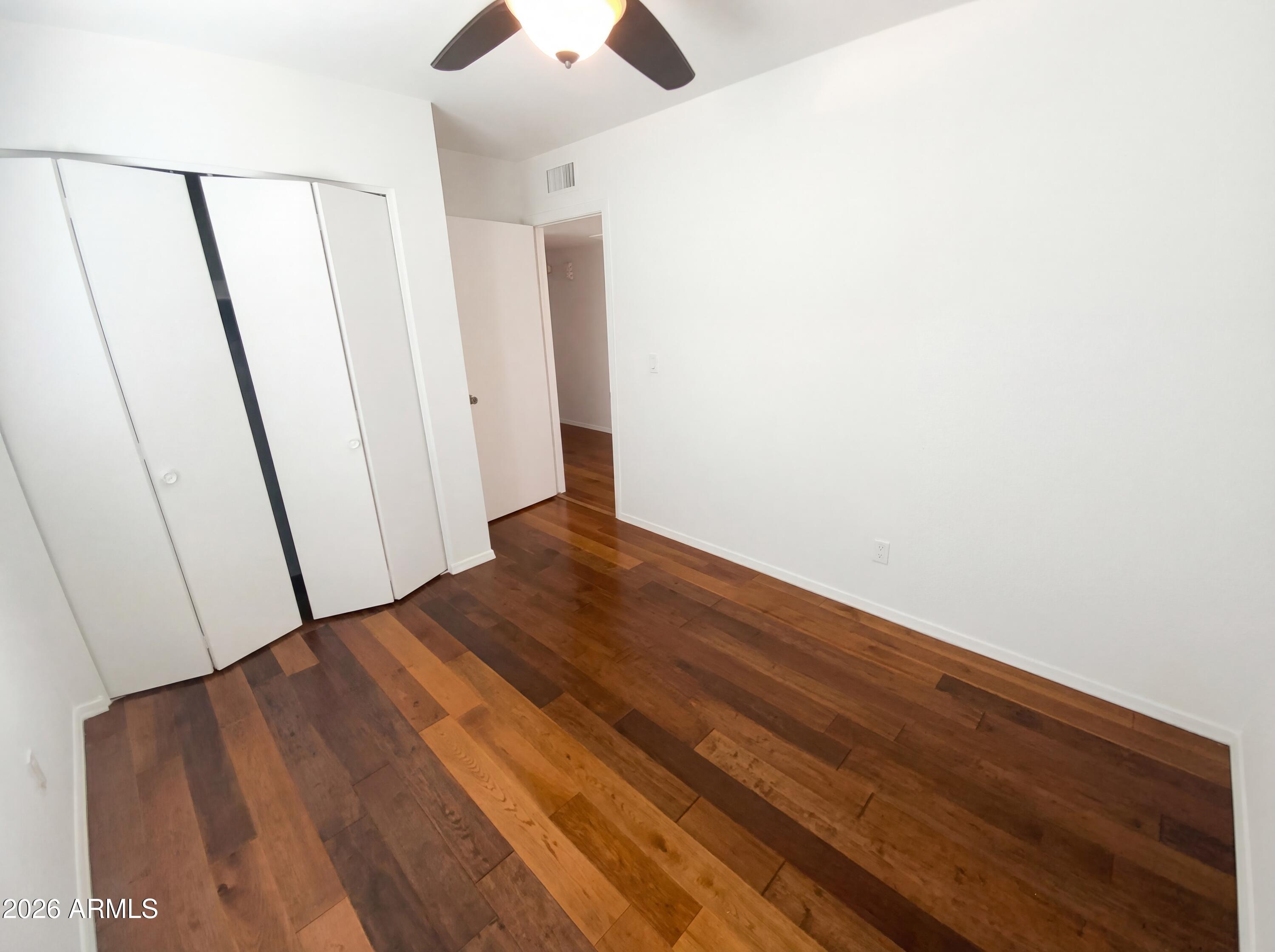 8508 West Ruth Avenue Peoria, AZ 85345 - Photo 4 of 17 a view of a hallway with wooden floor