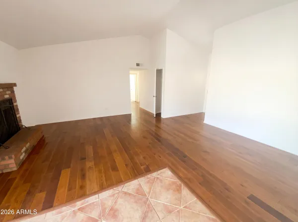a view of a room with wooden floor