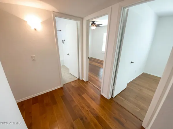 a view of a hallway with wooden floor