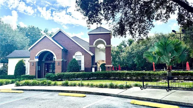 an aerial view of a house with a yard and lake view