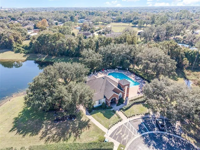 a view of house with outdoor seating and swimming pool