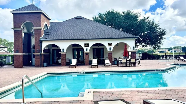 a view of a chairs and table in the patio in front of house